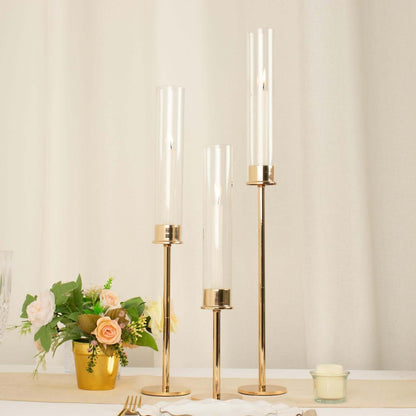 Set of 3 Gold Metal Clear Glass Hurricane Candle Stands, Taper Candlestick Holders With Glass Chimney Candle Shades - 16", 20", 24" Pro Linens